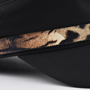 Black baker boy hat with brown leopard print chain detail and textured fabric finish