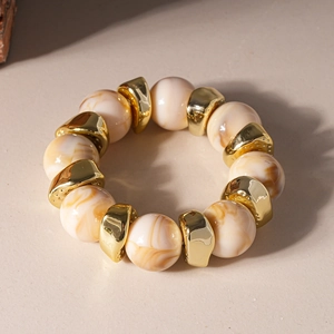 Detail view of retro acrylic marble beads with geometric gold metal spacers on a bracelet