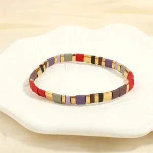 Detail of bohemian Tila bead bracelet with colorful matte cubes and gold metal accents