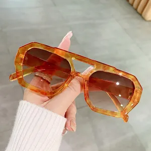 Irregular polygonal tortoise sunglasses with orange frame and brown gradient lenses