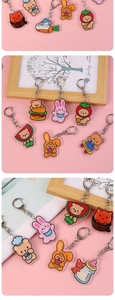 Close-up of cute acrylic cartoon bear and rabbit keychains with fruit and food elements