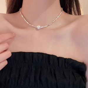 Elegant silver irregular beaded necklace with a round freshwater pearl on a model