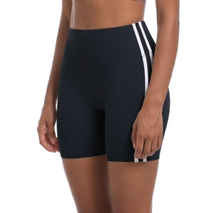 Detail showing high-waist yoga shorts with side stripes and elastic fabric texture