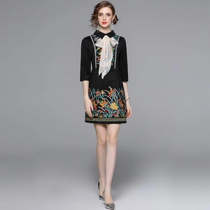 Slim black dress with floral embroidery, white bow neckline and stylish three-quarter sleeves
