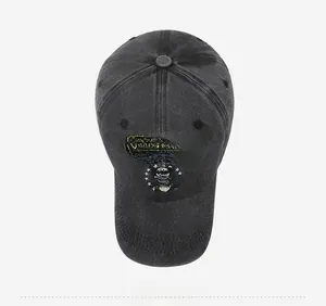 Detailed embroidery of Retired Air Force lettering on a washed dark gray cotton baseball cap