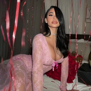 Detailed close-up of pink lace long-sleeved bodysuit featuring a deep V-neck design