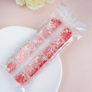 Macro view of 12-slot storage box with red heart and flower nail art glitter sequins