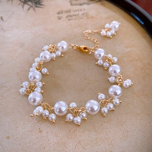 Detailed view of cluster pearl bracelet with gold-plated clasp and adjustable chain