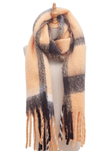 Detail showing the thick texture and fringe of an orange and black plaid scarf