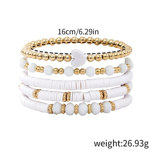 Detail of five bohemian beaded bracelets set with gold beads and white clay discs