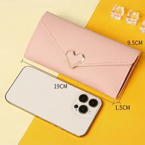 Pink trifold long wallet for women with golden heart buckle and slim envelope design