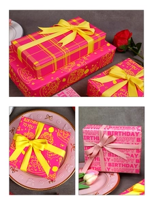 Detail of pink birthday gift wrapping paper with gold cake patterns and ribbon bows
