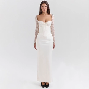 Close-up of white corset dress with delicate lace sleeves and elegant ribbon detail