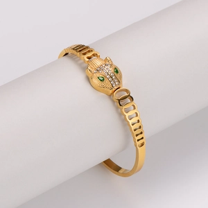 Vintage hollow 304 stainless steel leopard head bangle with gold plating and green eyes