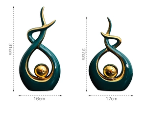 Detail of modern dark green and gold ceramic abstract sculptures showing height dimensions