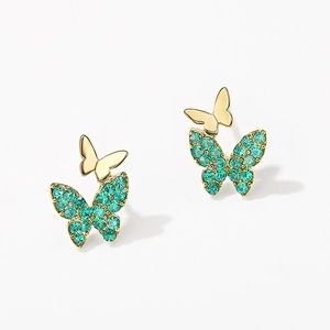 Elegant gold butterfly stud earrings with vibrant green crystals on white background