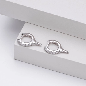 Macro shot of S925 sterling silver hoop earrings with clear crystals on geometric base