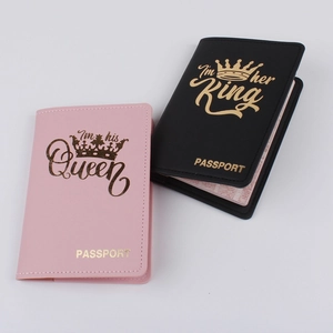 Detail of pink and black leather passport covers with gold crown and romantic typography
