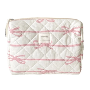 Quilted makeup bag with pink bow pattern and top zipper closure on white background