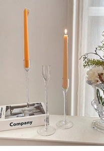 Detailed view of three transparent glass candle holders for elegant table decoration