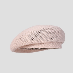 Side view detail of a breathable light pink knitted summer beret for women with a wide brim