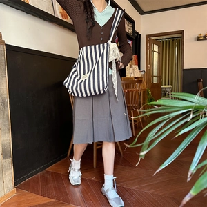 Chic blue striped canvas tote bag with white lace bow detail worn with casual outfit
