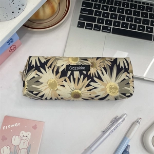 Detailed top view of the vintage floral pencil case with daisy patterns and stationery