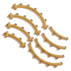 Detailed shot of golden multi-hole curved connectors for DIY bohemian jewelry making