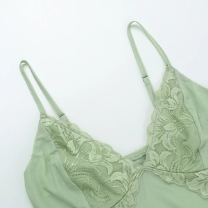 Close-up of mint green lace floral pattern and breathable mesh fabric on V-neck camisole