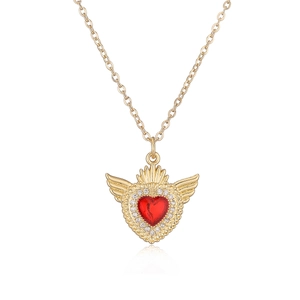 Gold plated necklace with red gemstone heart and wings pendant on white background
