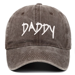 Close-up of white DADDY embroidery on distressed washed denim grey baseball cap