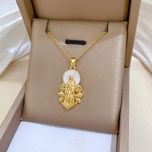 Close-up of Virgin Mary relief on shell pendant with floral gold details