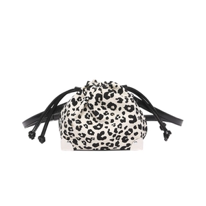 Detail of leopard print bucket bag with silver metal corners and drawstring closure