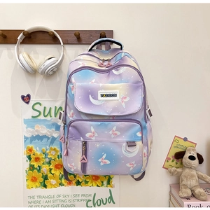 Close-up of butterfly and moon patterns on a purple gradient backpack with fashion tag
