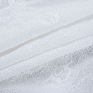 Close-up of white lace fabric detailing intricate floral crochet and mesh texture