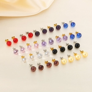 Elegant multi-color crystal and pearl earrings set on silk background for women