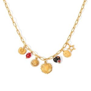 Close-up of gold link necklace with sun, heart, star and bead pendants on white backdrop