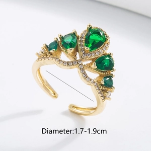 Detail of 18K gold plated ring with green teardrop stones and white zircon accents