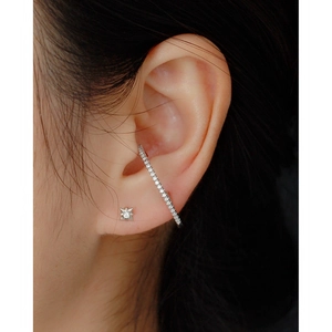 Close-up of S925 silver star stud and sparkling full diamond ear cuff on a model's ear