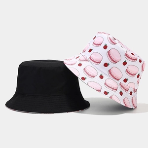 Detail view of double-sided bucket hat with black design and pink macaron prints