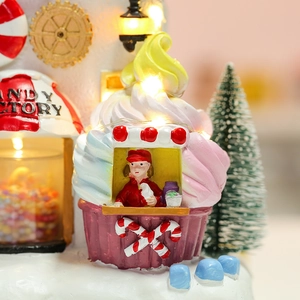 Detailed view of resin candy factory house with LED lighting and cupcake roof decor