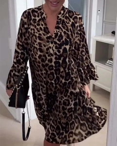 Detail of leopard print dress with elegant v-neckline and ruffled long sleeve cuffs