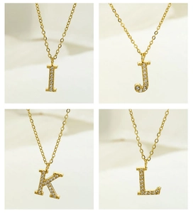 Detailed view of four gold zircon initial necklaces featuring letters I, J, K, and L