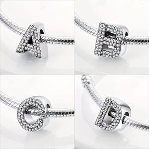 Detail view of silver-plated micro-paved crystal alphabet beads A, B, C, D on a snake chain