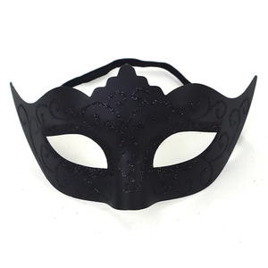 Detail of black masquerade mask with sequin floral patterns and elastic strap on white background