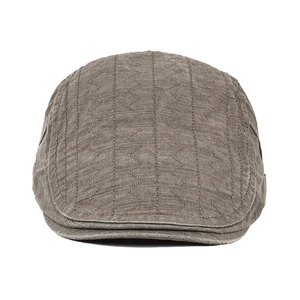 Detailed view of dark brown cotton flat cap featuring vertical wavy stitched embroidery lines