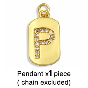 Macro shot of gold letter P pendant with white zircon stones and sleek metal finish