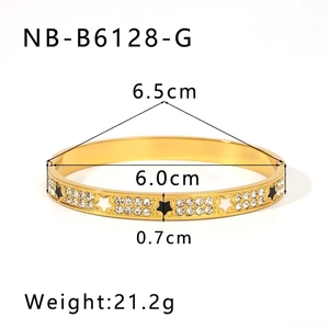 Close-up of 18K gold-plated bangle featuring white inlay stars and sparkling crystals