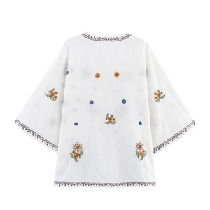 White boho shirt with colorful floral embroidery on the back and long sleeves