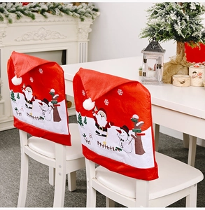 Detail of Christmas chair covers with Santa and Snowman motifs in a cozy dining setting